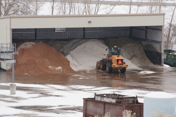 3 sided shed with stockpiles of deicing materials