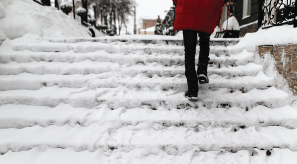 Person walking up icy stairs